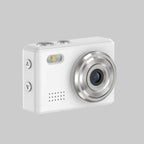 White digital camera with silver accents on a white background