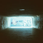 Dark tunnel with graffiti on a wall illuminated by a light source. Shot with SerenoVita VitaCam f(x) Film Camera 