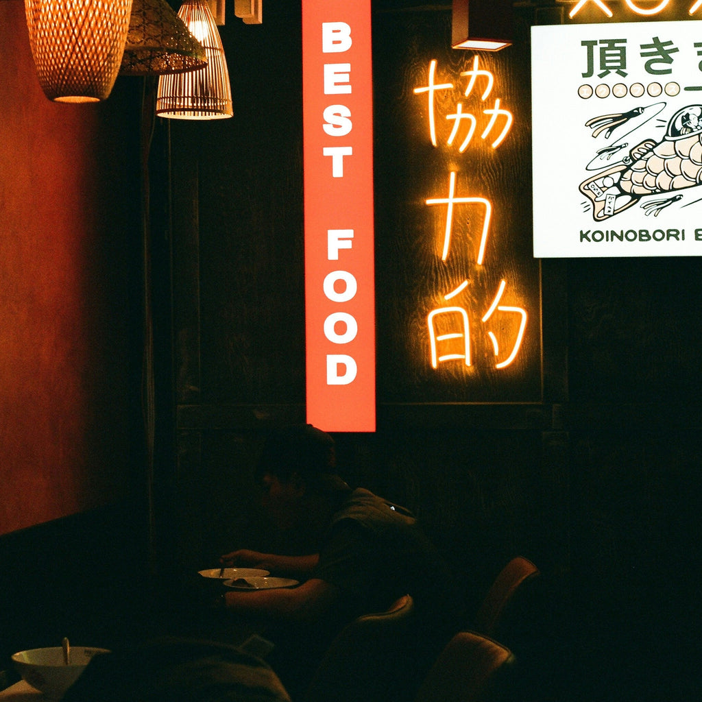 Neon sign with text and logo in a dark setting in Japan. Shot with SerenoVita VitaCam f(x) Film Camera 