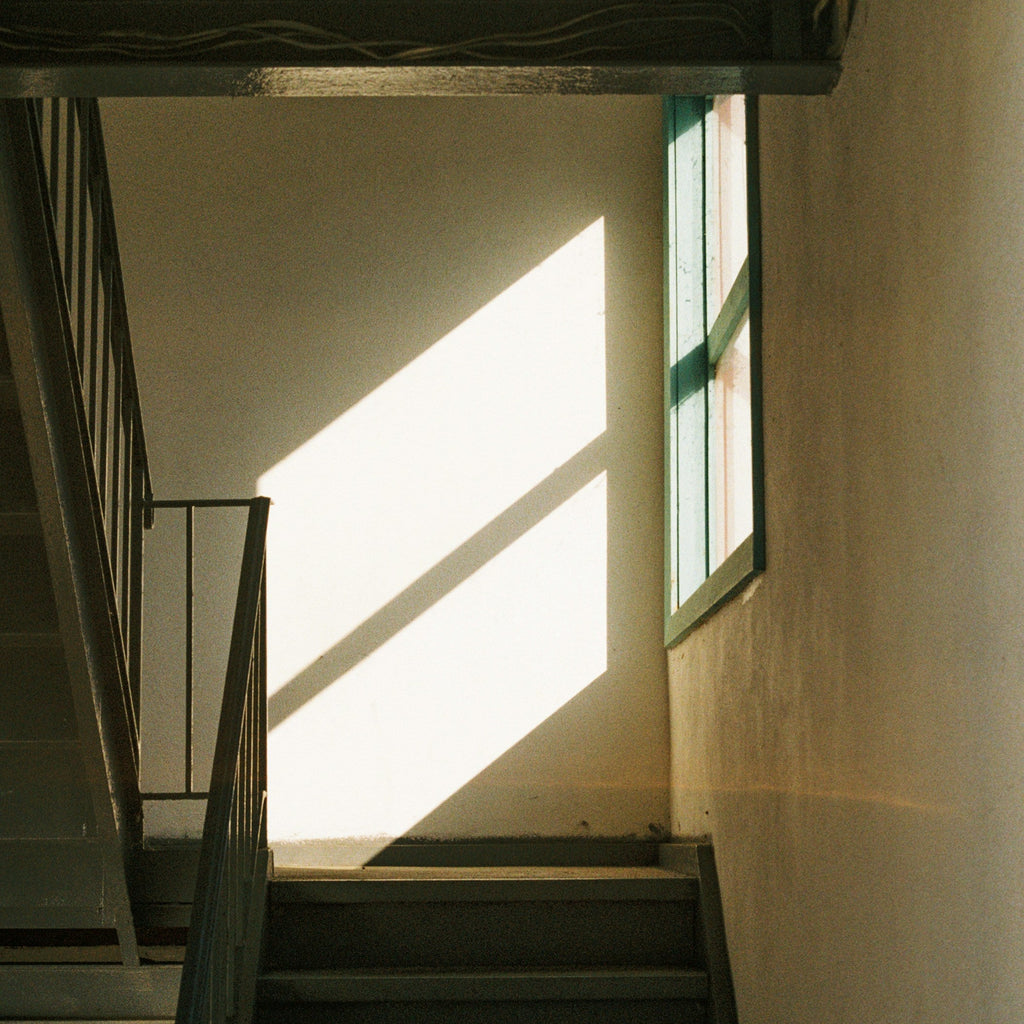Stairwell with sunlight streaming through a window. Shot with SerenoVita VitaCam f(x) Film Camera 